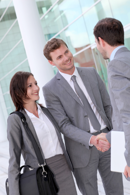 Business people meeting outside office building