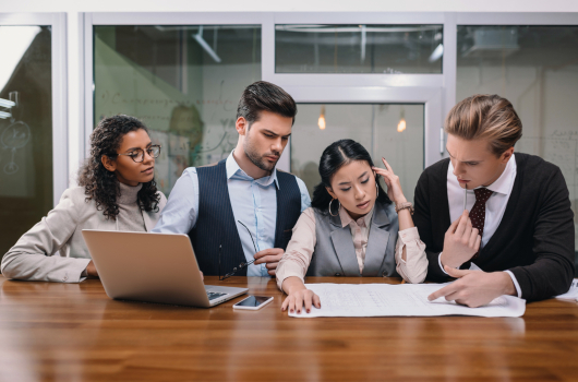 Business group reviewing document